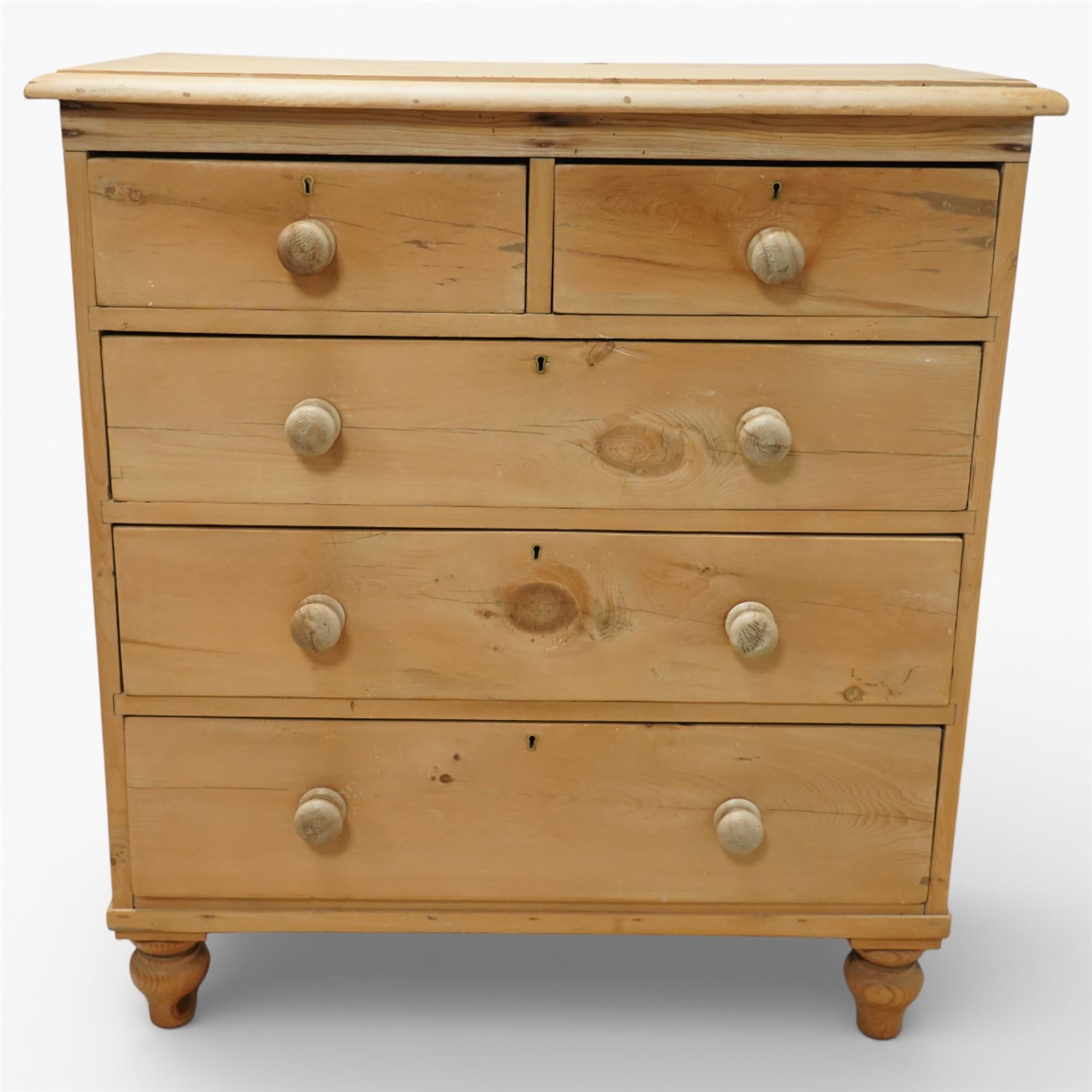 Victorian pine chest of drawers, with rounded top over two short and three long drawers fitted with turned wooden knob handles, raised on turned bun feet