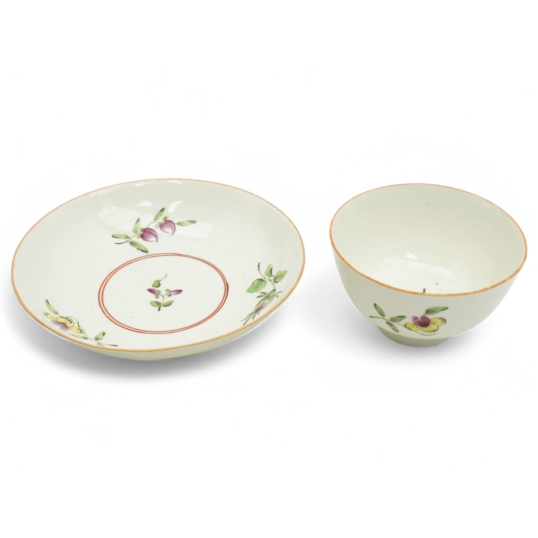 Worcester tea bowl and saucer, c.1770, painted with polychromatic floral sprays within blue borders, bearing crescent marks to base, with another similar early example, unmarked