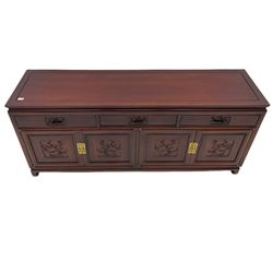 Chinese hardwood sideboard, three drawers above four cupboards, the doors relief carved with flowers and birds 