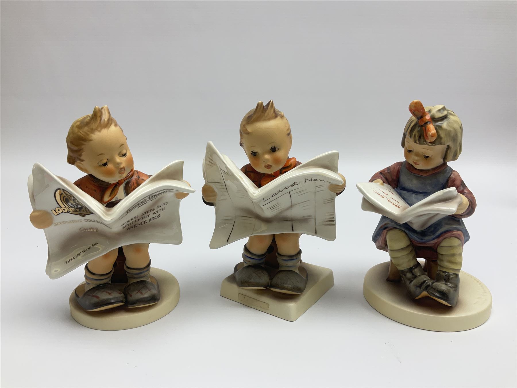 Thirty Hummel figures by Goebel, to include Saluting the Peacekeepers of Operation Joint Endeavor, on wooden plinth, Call to Glory, Celebrate with Song and Soldier Boy