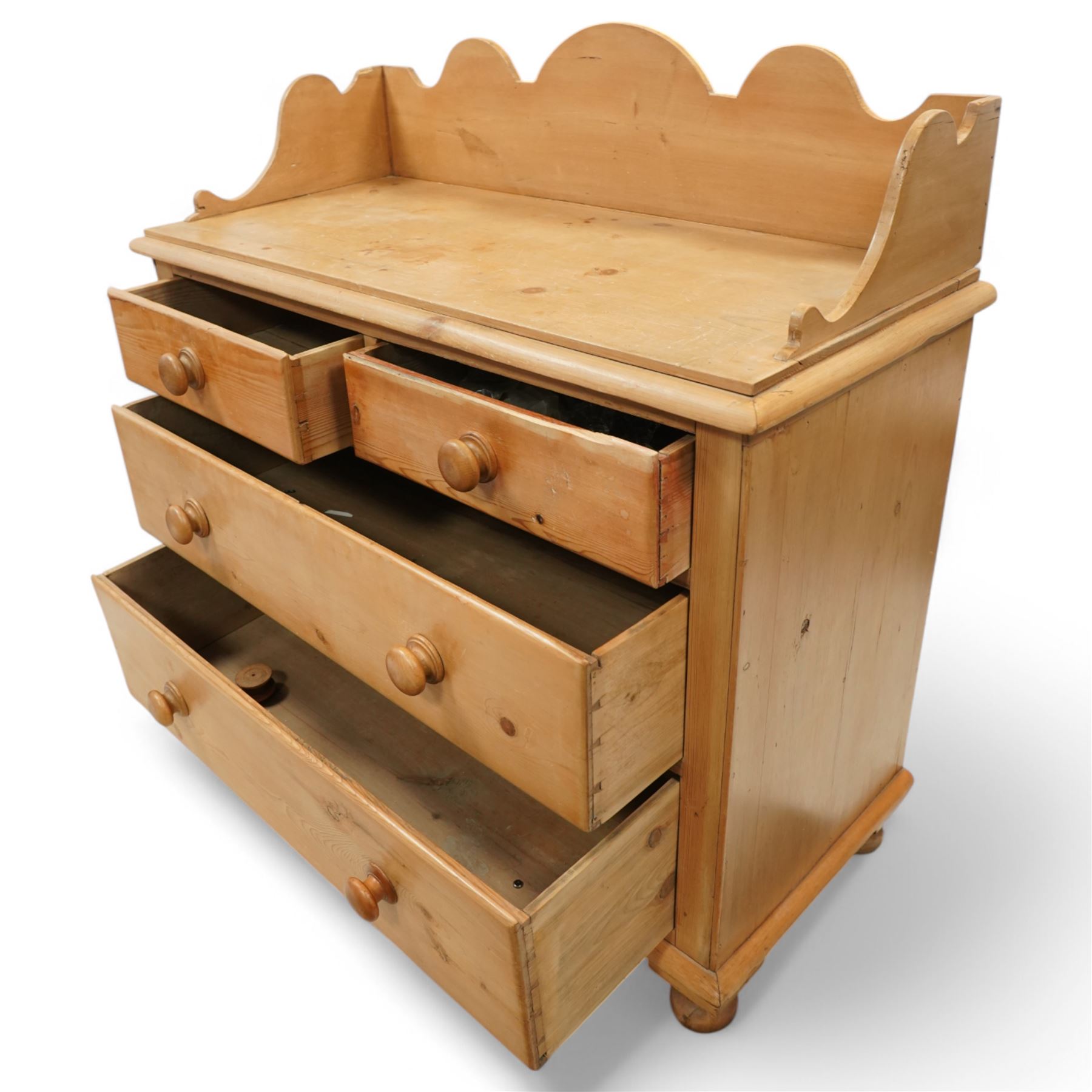 Victorian pine pot cupboard washstand, shaped arched gallery back with scroll carved ends, rectangular top over two short and two long drawers with turned wooden knobs, raised on squat turned feet