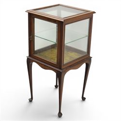 Edwardian bijouterie two tier table, glazed top and sides with inlay surround, glazed door enclosing a single shelf and baized lined interior, raised on cabriole supports