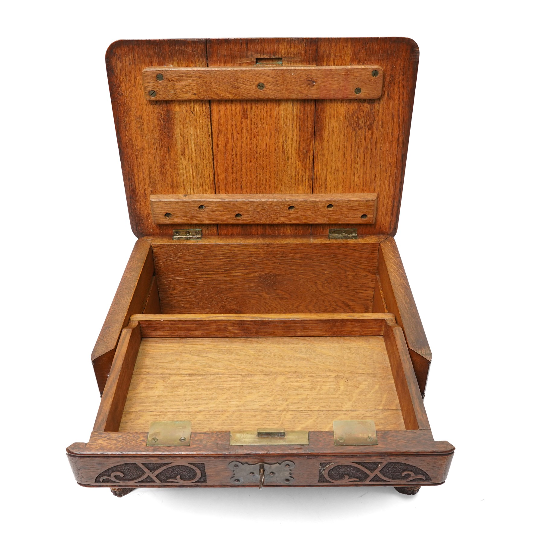 Arts & Crafts Design oak sewing box carved with initials and dated 1907, with sliding top, lion mask ring handles on shaped supports. W36cm