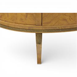 Edwardian satin walnut display cabinet, bowed oval form with moulded and dentil cornice over glazed panels, enclosing a laurel wreath damask interior with adjustable glass shelves, the frame applied with gilt metal bead mouldings and mask mounts, enclosing a shelved interior, raised on cabriole supports with moulded feet
