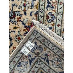 Persian Kashan ivory ground carpet, the field decorated with interlacing foliate branches and stylised plant motifs, scrolling border decorated with repeating palmettes, within floral pattern guard bands