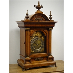  Edwardian oak architectural mantle clock circa 1908, arched top with urn and spire finials, square brass dial with silvered Roman chapter, enclosed by brass caped column door on brass paw feet, Jungans twin train movement striking the quarter hours on two coils, W33cm, H58cm, D21cm  