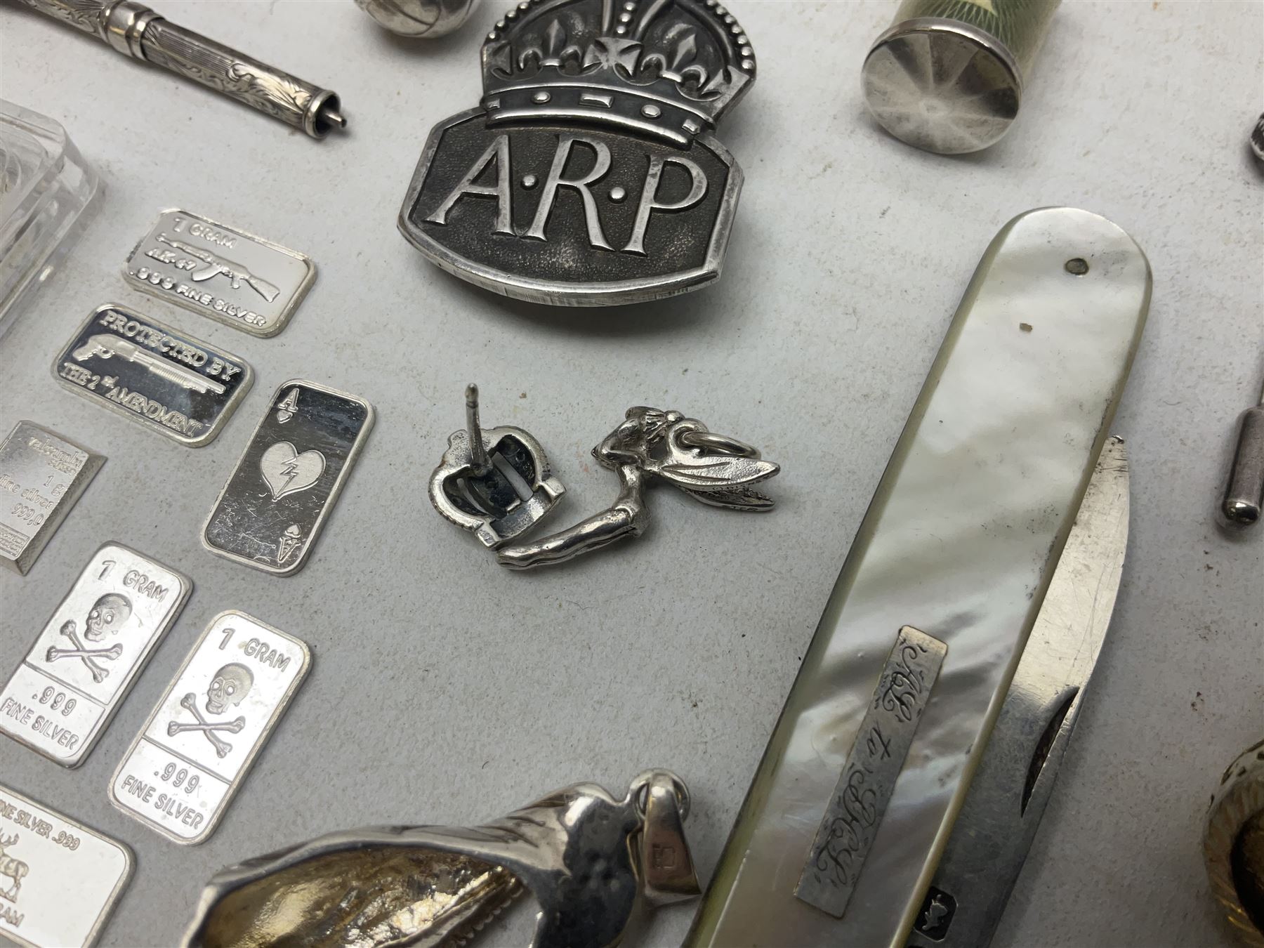 Silver mother of pearl handled fruit knife, silver jewellery including masonic pendant necklace, shell pendant, coin ring, Claddagh ring and charms etc, and a collection of ingots