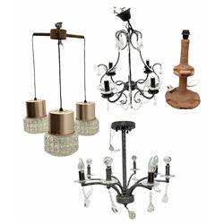 Terracotta studio pottery lamp base with carved detail and geometric knop and base, H45cm, together with a black chandelier with drops, Mid century teak light fitting with three drop down clear glass pendants and copper mounts, H54cm, and Rhinestone and black eight branched chandelier