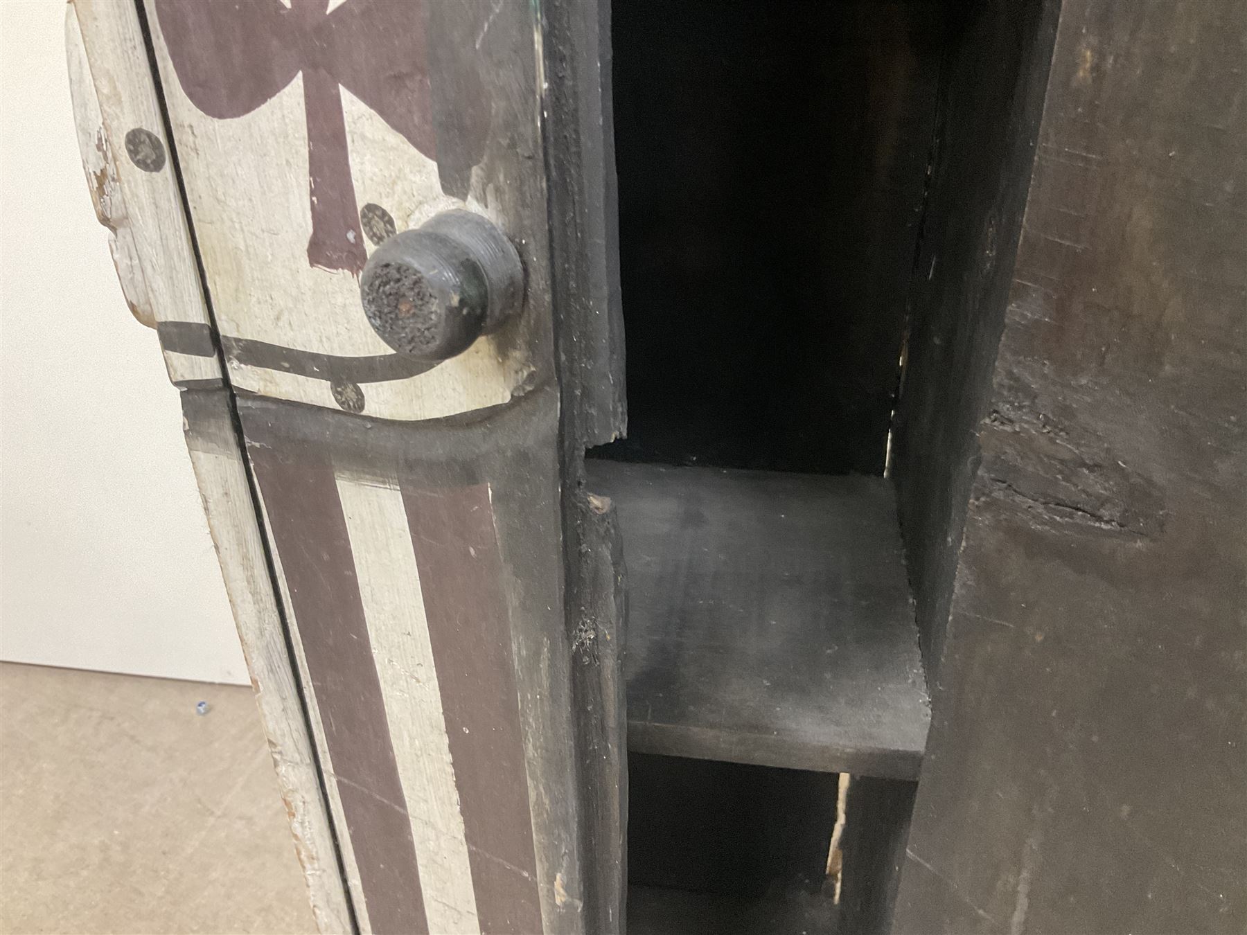 Folk art circus clown cabinet, the the two hinged doors with bow tie decoration opening to reveal fitted shelved interior, the body painted with polka dots and spades, H121cm