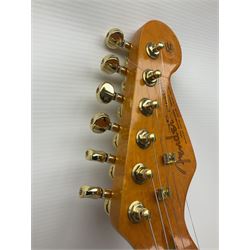 Copy of a Fender Stratocaster electric guitar in black with Wilkinson bridge, lock-in tuners, synchronised tremolo and various patent numbers; L99cm; in hard carrying case with strap and digital tuner