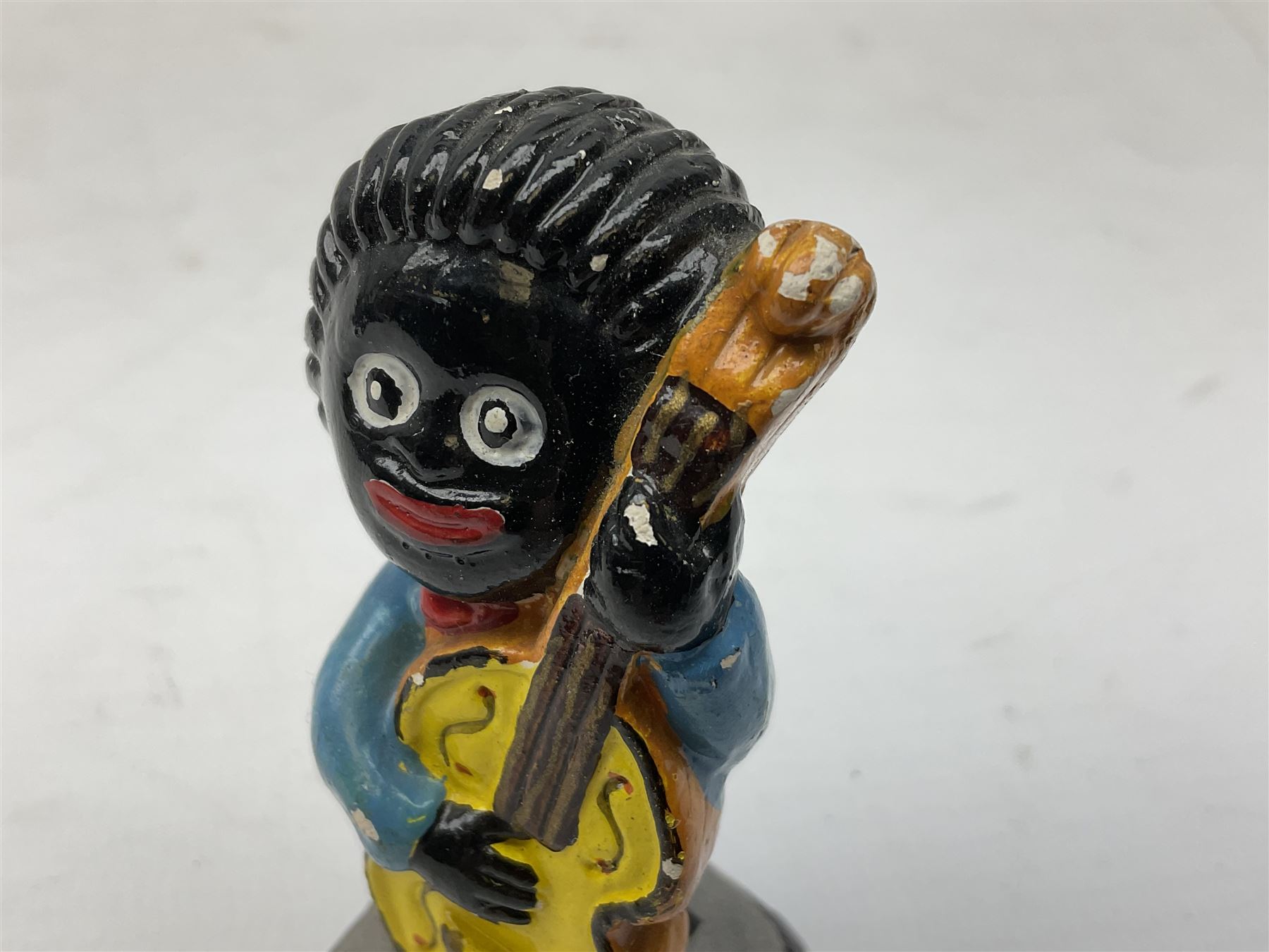 Robinson Jam plaster Golly band, including drummer and singer, H7.5cm

Originally handmade by mothers in Africa for their children from old fabric and cloth, the golly doll was adopted as the mascot and trademark for the Robertson's confectionery brand around 1910 after the company's founder John Robertson visited the US and noticed children playing with them. Robertson's Gollies have been collected by people across the UK and around the world for generations but garnered a contentious image in the 1980s because of links to racism. The trademark was removed from Robertson's branding in 2001.