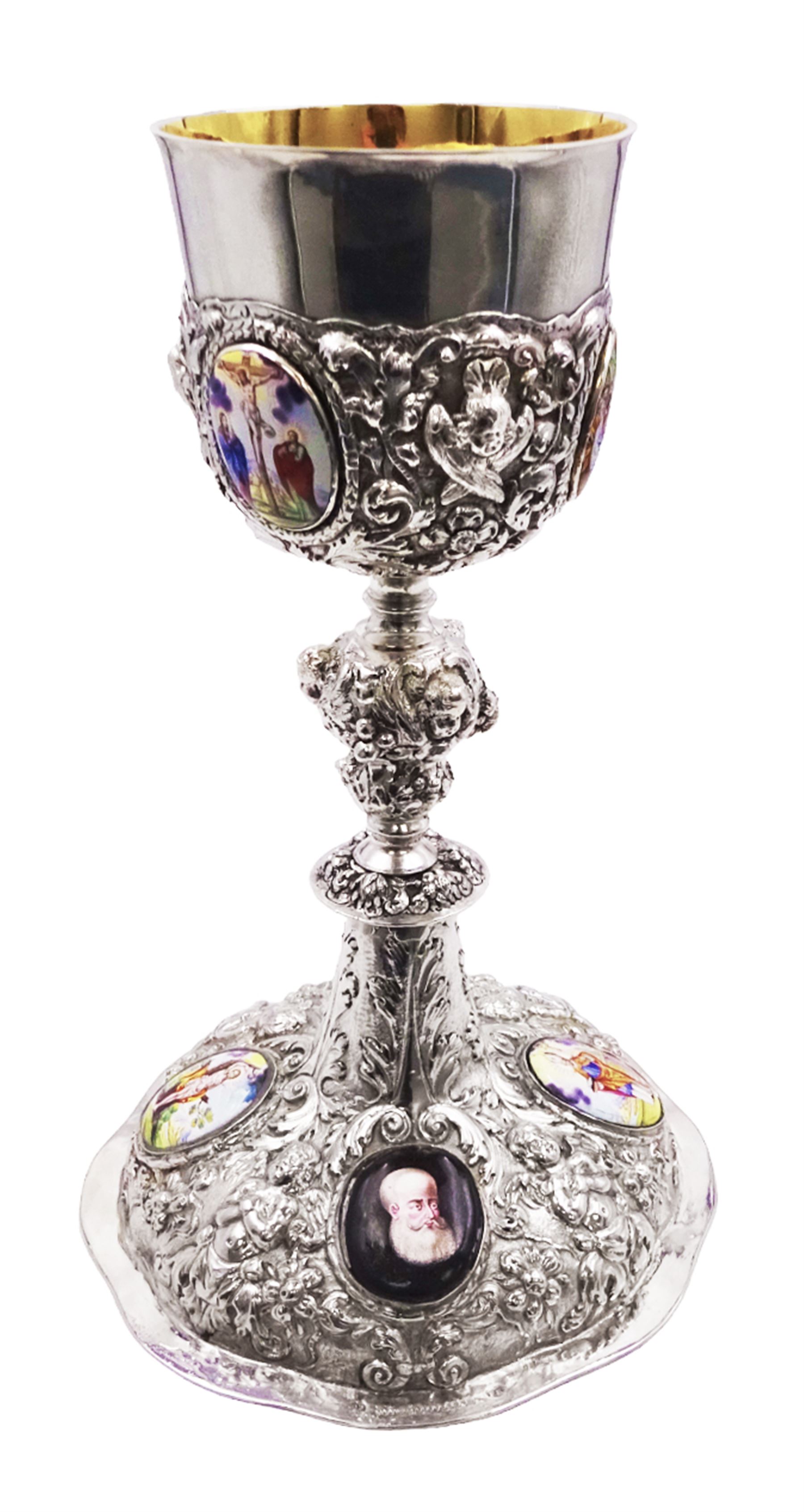 German silver chalice, the bowl, stem and foot each with 19th century repousse and chased decoration depicting putti masks, C scrolls and flowers, set with two hand painted porcelain roundels, possibly Berlin, and six later applied enamel roundels, each depicting religious scenes, the gilded bowl upon knopped stem and spreading octofoil foot, the base with marks for Munich, c.1695 and maker's mark FK