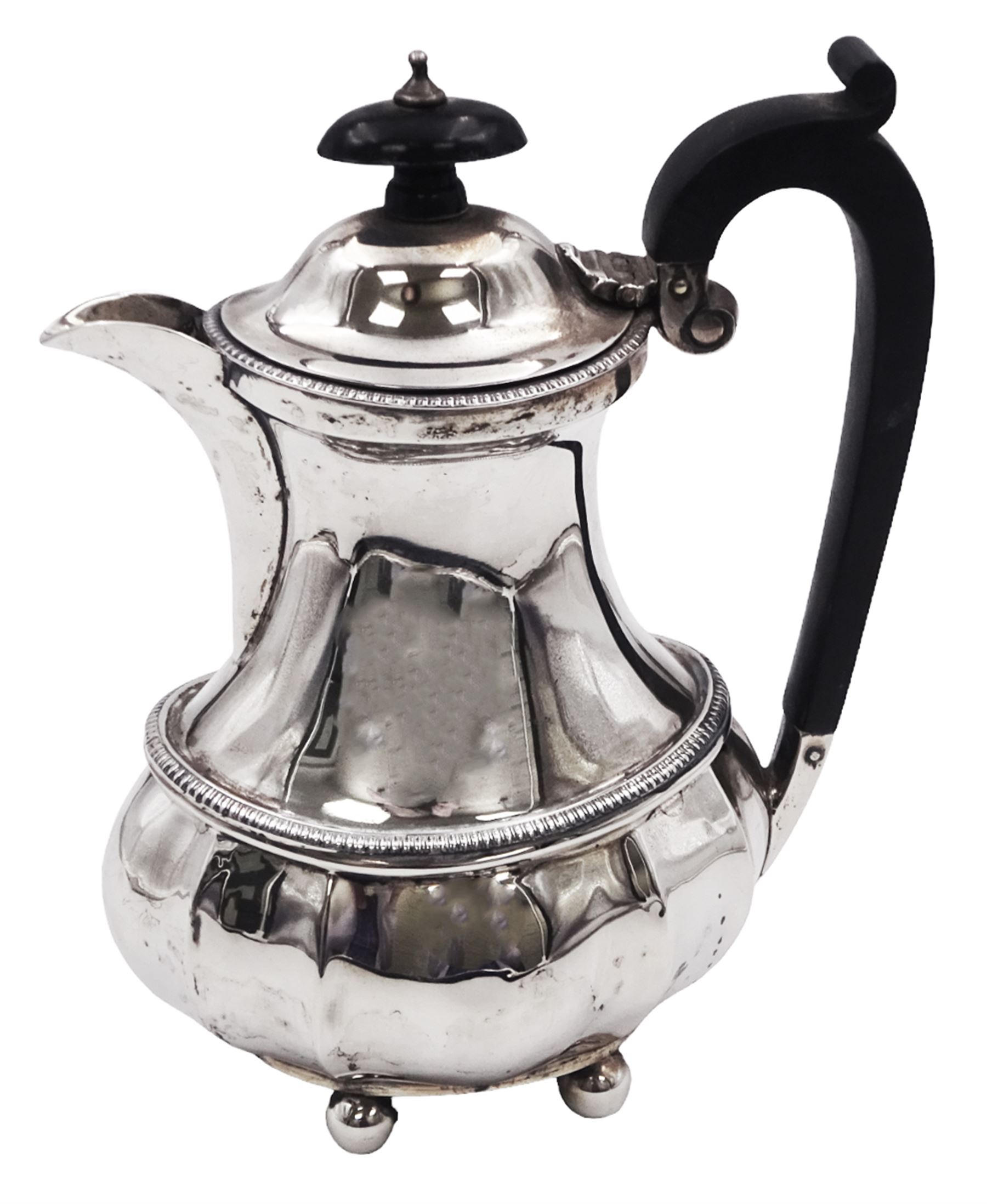 1920s silver hot water pot, of part fluted baluster form, with gadrooned girdle and rim and ebonised handle and finial, upon four bun feet, hallmarked Ernest Druiff & Co, Birmingham 1920