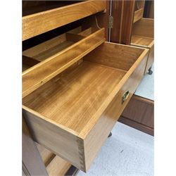 Wylie & Lochhead, Glasgow - early 20th century mahogany and satinwood double wardrobe, projecting cornice over panelled doors, interior fitted with mirrored door, shelves, drawers, hooks and hanging rail, raised on bracket supports with ceramic castors