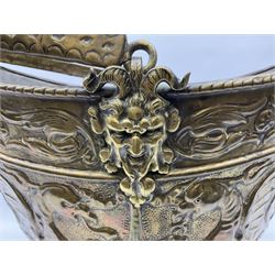 19th Century brass embossed coal scuttle with double-sided hinged lid, raised on a spreading foot and another similar with swing handle decorated with winged dragons, max H44cm