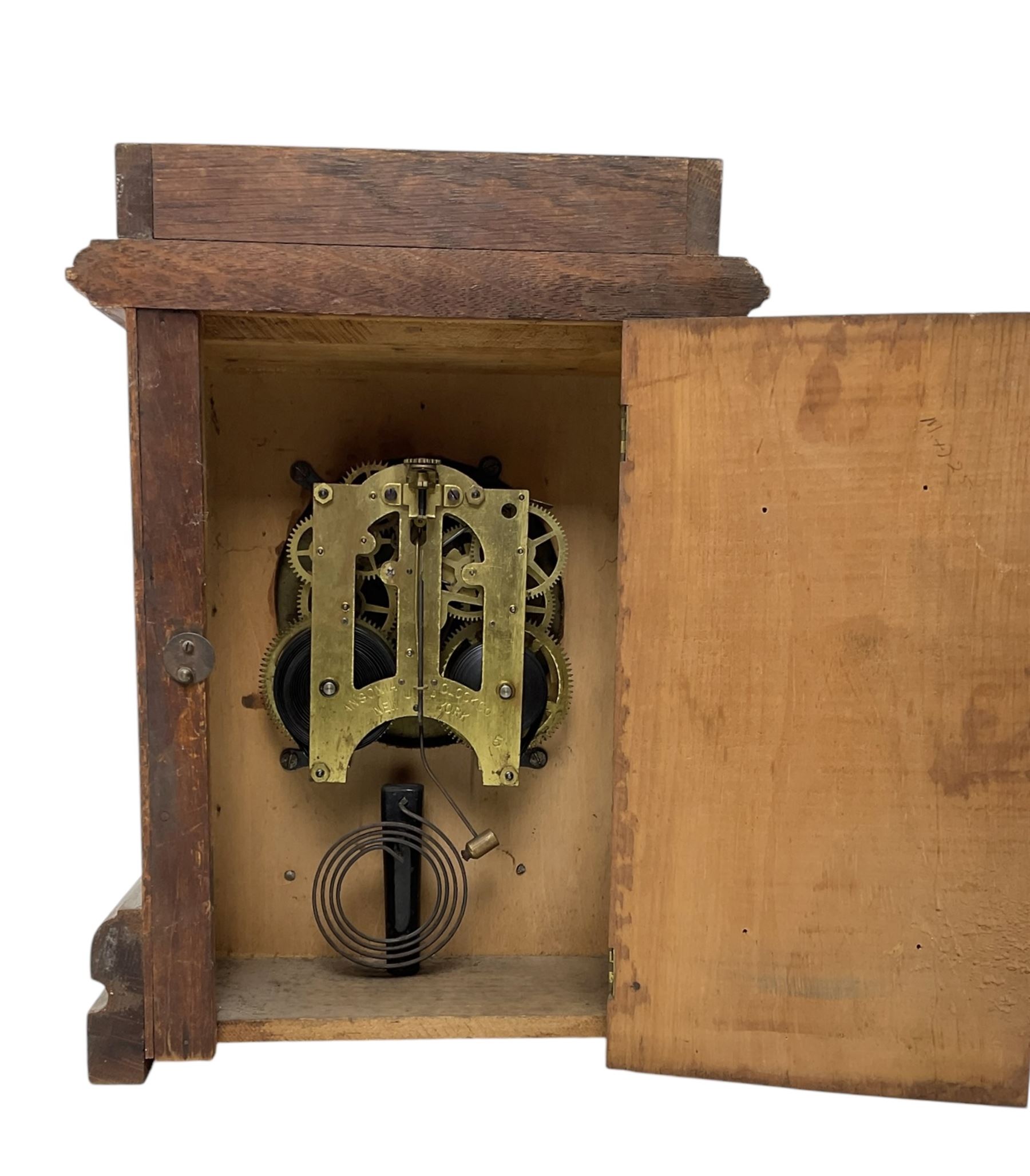 Ansonia- American oak cased 8-day mantle clock striking the hours on a gong. With key.