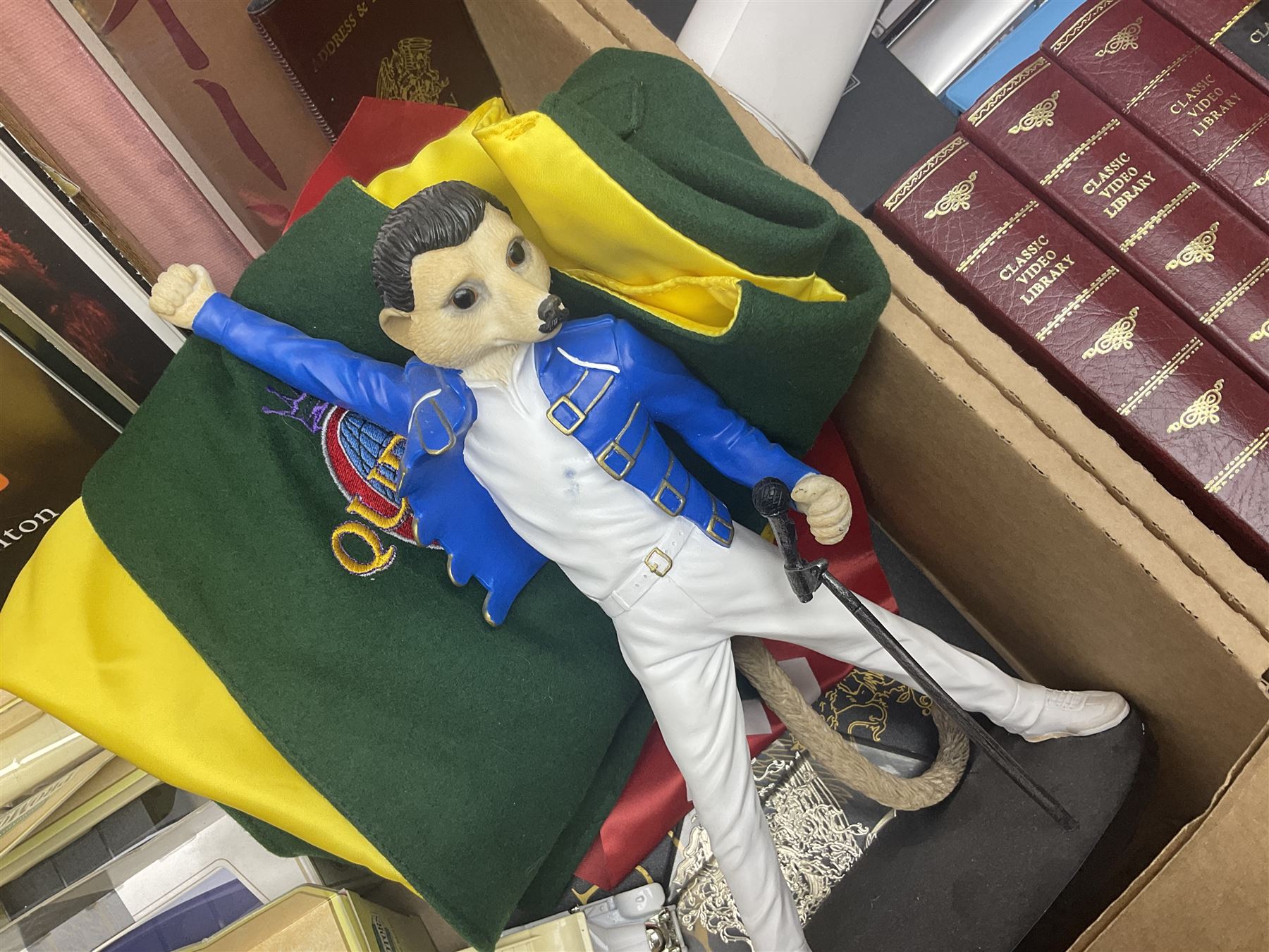 Mostly Queen and Freddie Mercury interest items, including pin badges, newspaper cuttings, diecast 'promotional' vehicles, special edition Pop Rocks figure of Freddie Mercury, VHS tapes, two charity certificates signed by Brian May and Roger Taylor, poster etc, in two boxes 