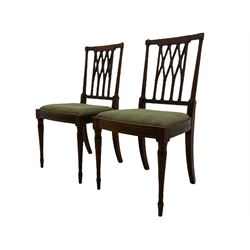 Pair 19th century mahogany side chairs, the inlaid and reed carved cresting rail over lattice back, the turned uprights with carved foliage capitals, upholstered drop in seat, lobe carved and turned supports