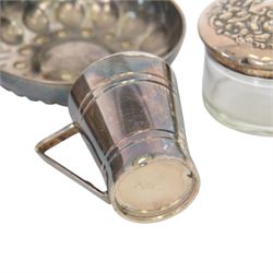 Silver mounted trinket box, with embossed lid, hallmarked, silver lidded glass jar stamped sterling, silver plated measure and a silver plated dish