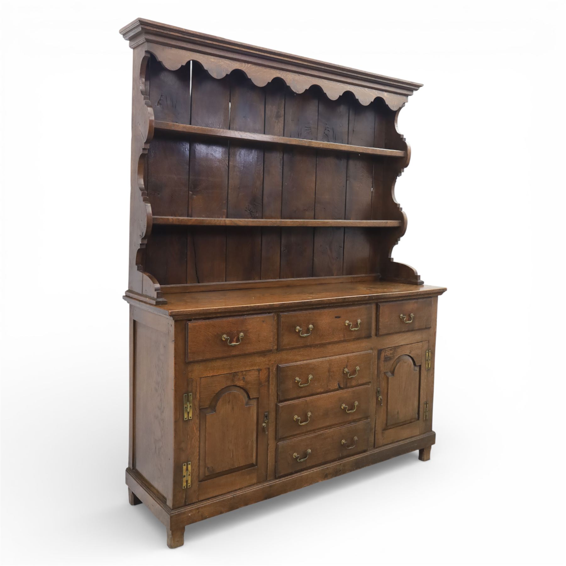 Georgian design oak dresser, the raised plate rack with shaped sides and two open shelves, upon a dresser base fitted with six drawers and two cupboard doors, and short block feet 