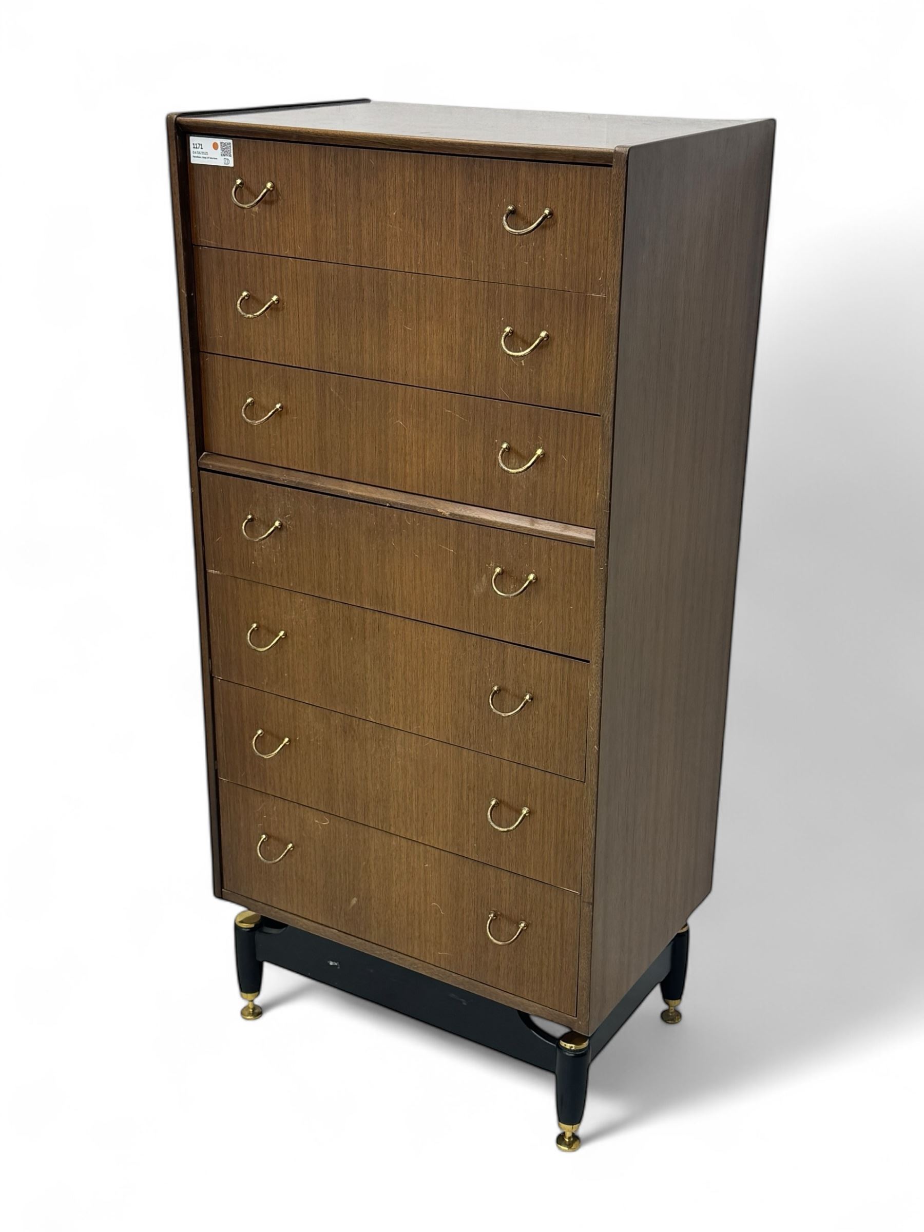 G-Plan teak tallboy, seven drawer chest with brass loop handles, ebonise base with adjustable brass terminals