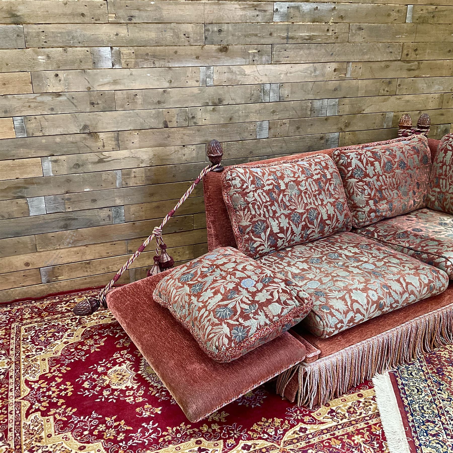 Knole type drop arm sofa with cushions in a traditional patterned upholstery,