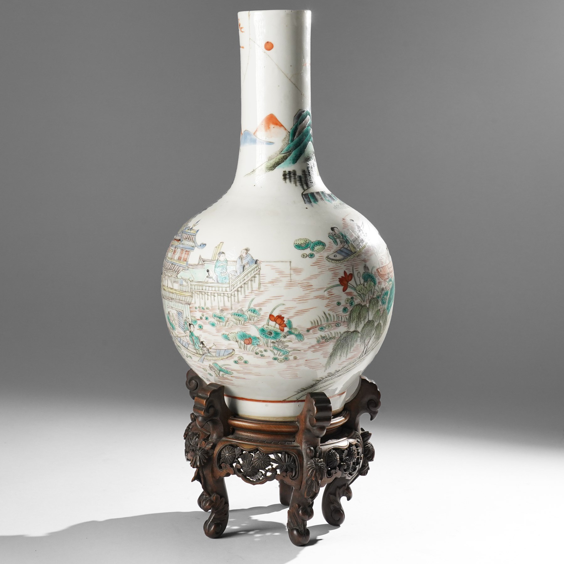 Chinese Kangxi period famille verte vase, the body finely painted with a continuous narrative scene of figures inside and out of a pavilion complex, beside a river, rocks and trees, character mark to base, raised upon a hardwood stand, overall H47cm