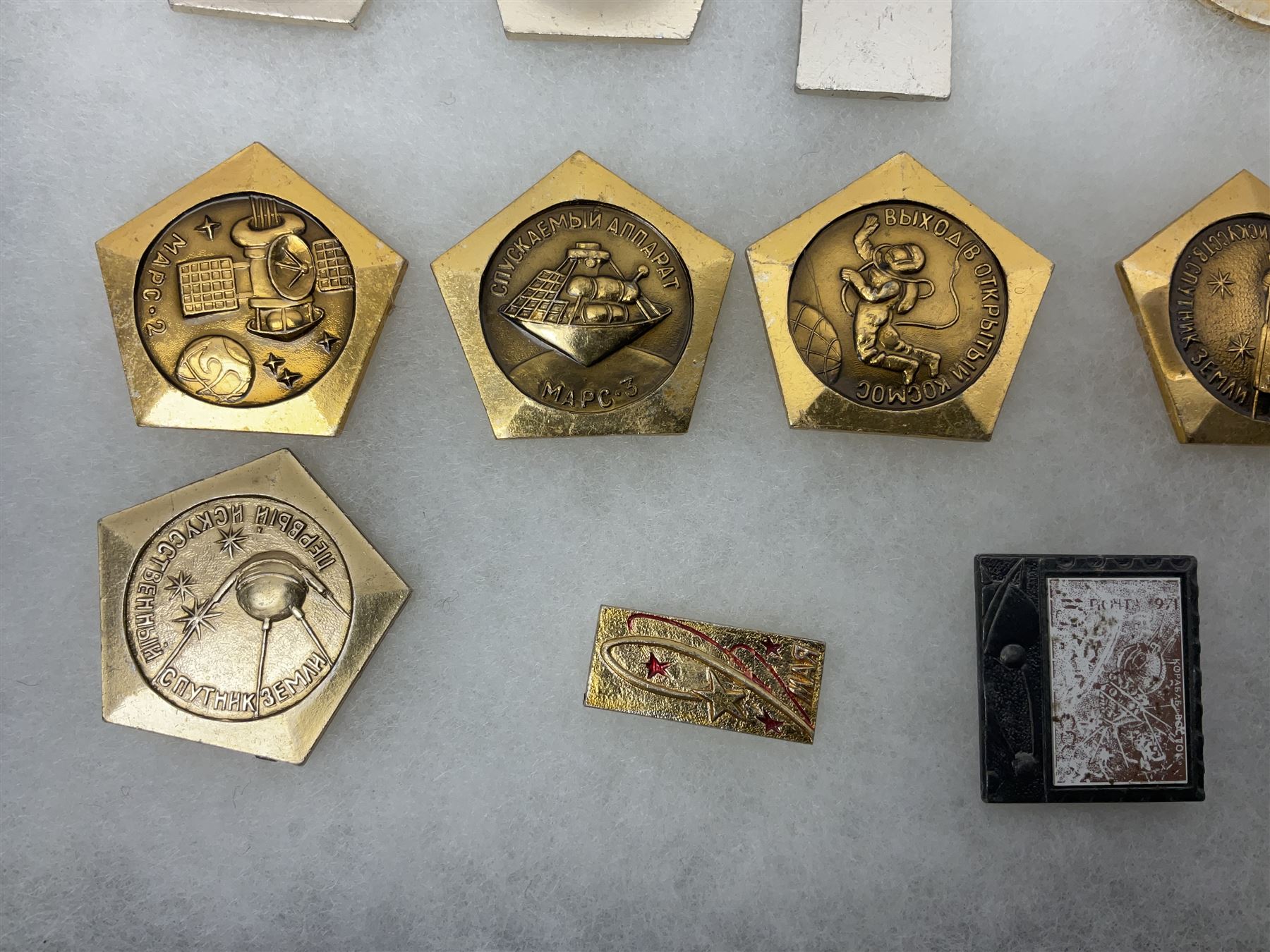 Twenty-six Russian Soviet Space badges 1960s/70s; in small display case