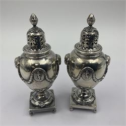 Early 20th century silver five piece cruet set, comprising pair of peppers, pair of open salts with blue glass liners, and mustard and cover, each decorated with rams masks, neo-classical patera and husk swags, and raised upon square plinth with four husk feet, hallmarked Robert Frederick Fox, London 1911, 1912 and 1913