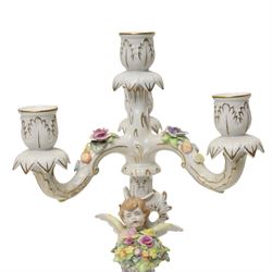 Pair of German porcelain three branch candelabra, the based modelled with putti holding flowers, printed blue mark to base, H35cm (2)