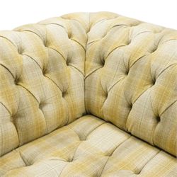 Late 20th century Chesterfield style two seat sofa, upholstered in muted green and yellow tartan fabric with buttoned back, arms and seat, on turned front supports with brass castors