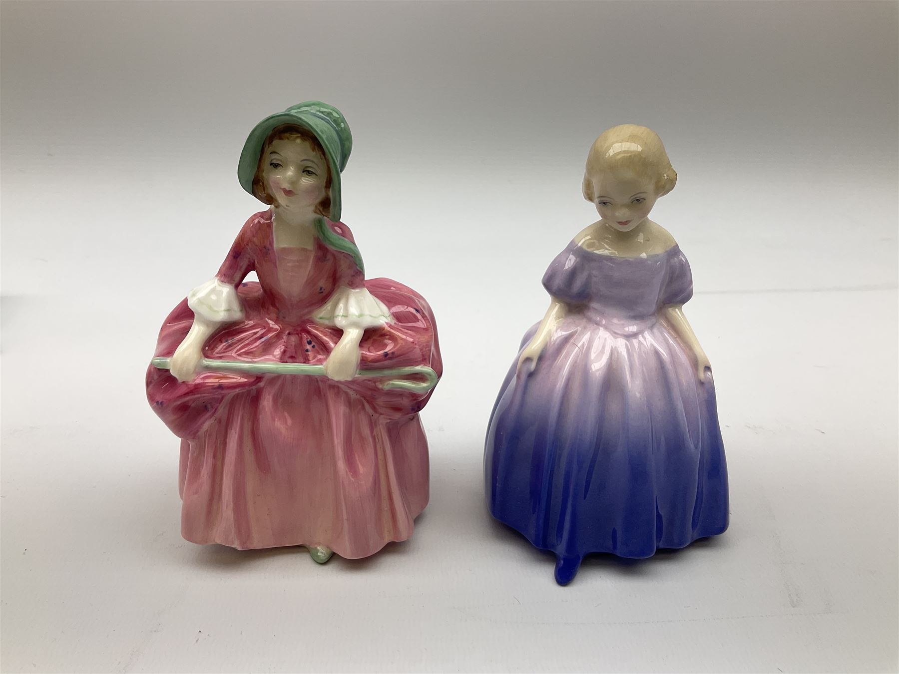 Group of figures, comprising six Royal Doulton examples, Daydreams HN1731, Silks and Ribbons HN2017, Tom Sawyer HN2926, Marie HN1370, Bo-Peep HN1811, and Tinkle Bell HN1677, together with a Dresden type 'lace' example, and a Coalport 'Swiss Cottage', (8)