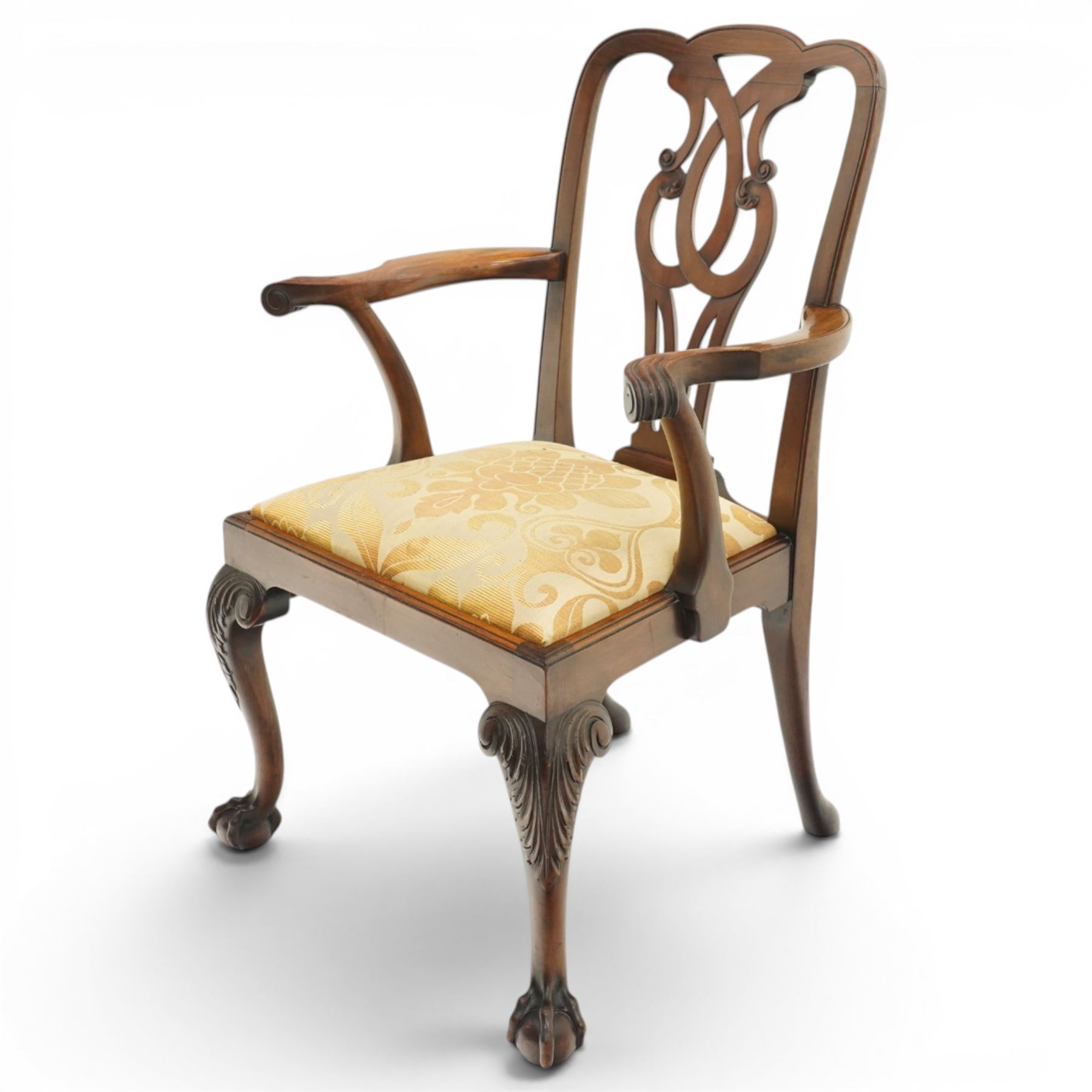 Late 19th century Chippendale style mahogany desk chair, with pierced splat and shaped and scrolled arms, raised on front claw and ball supports