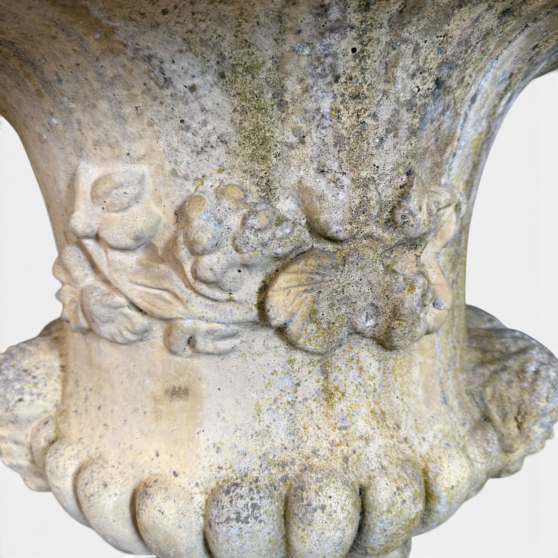 Pair of large cast stone garden urns, circular form with egg and dart border, tapering gadrooned bowl with cast handles and detail