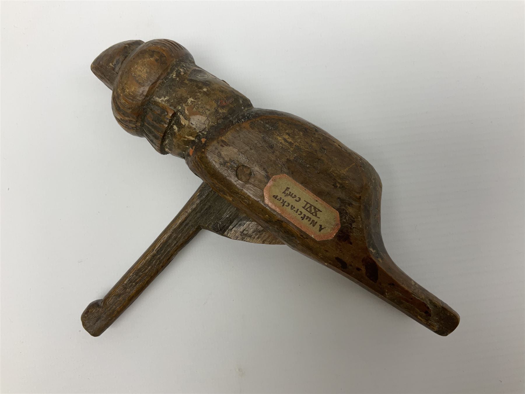 Rare primitive treen lever action nutcracker, probably late 17th/early 18th century, carved in the form of a man, with old collector label to side inscribed 'A Nutcracker XVI Century', H18cm