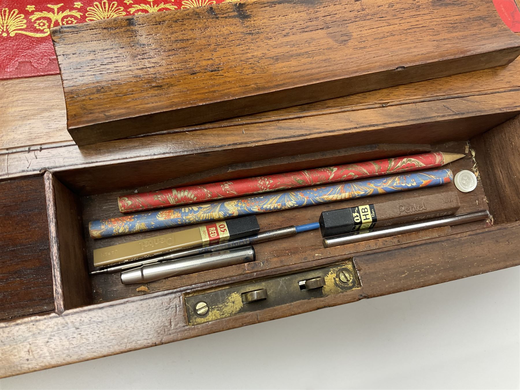 19th century burr yew wood tea caddy, of sarcophagus form, with strung details and brass mounts, the interior split into three compartments, upon four brass bun feet, together with an oak and brass bound writing slope, with red leather interior with gilt detailing, largest H16cm, W40cm