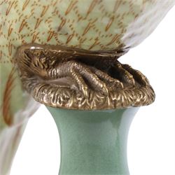 Pair candlesticks, modelled as parrots, upon urn shaped mounts with gilt detail, H48cm