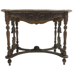  19th century walnut centre table, shaped top carved with central cartouche and extending scrolled foliage, the shaped frieze rails carved with scrolling acanthus leaves, turned supports with central end supports carved with flower heads and scrolls, curved x-framed stretcher carved with a central mask depicting a girl in a bonnet, on turned and carved feet