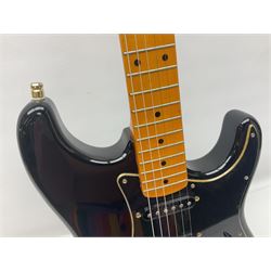 Copy of a Fender Stratocaster electric guitar in black with Wilkinson bridge, lock-in tuners, synchronised tremolo and various patent numbers; L99cm; in hard carrying case with strap and digital tuner