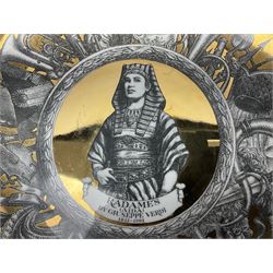 Three Fornasetti plates from the Melodramma series, each depicting a operatic portraits within a border of operatic emblems on gilt ground, with printed mark beneath, D25cm 