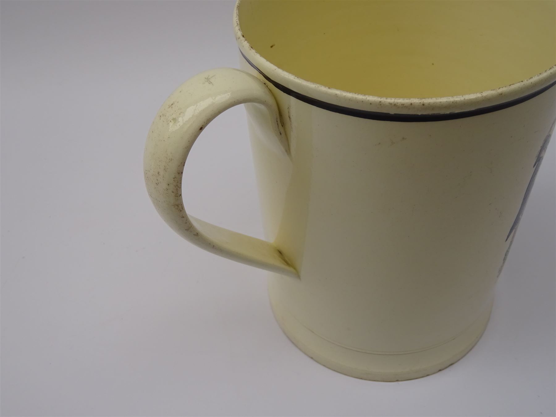 Early 19th century Sunderland Dawson & Co creamware pottery mug, the cylindrical body black transfer printed and polychrome detailed with a circular panel of a three-masted ship flanked by two figures of Peace and Plenty, above a panel containing verse 'May Peace with Plenty on our Nation smile [...]' H15cm D11cm