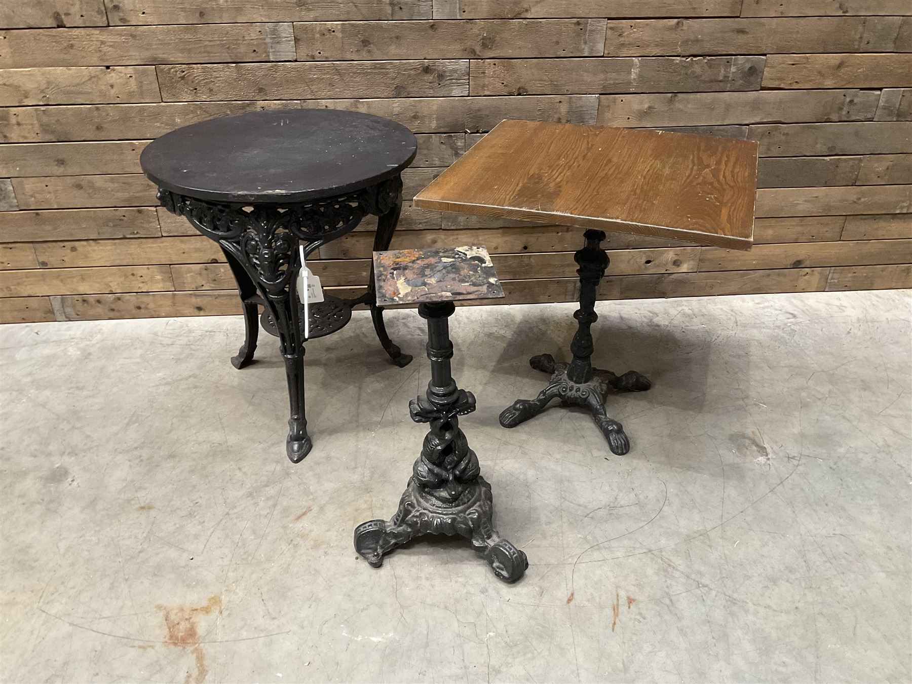 Cast iron Britannia circular pub table, and two pedestal cast iron bases (3)