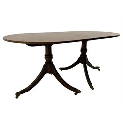 Regency style mahogany twin pedestal dining table, crossbanded border with brass inlay, with leaf