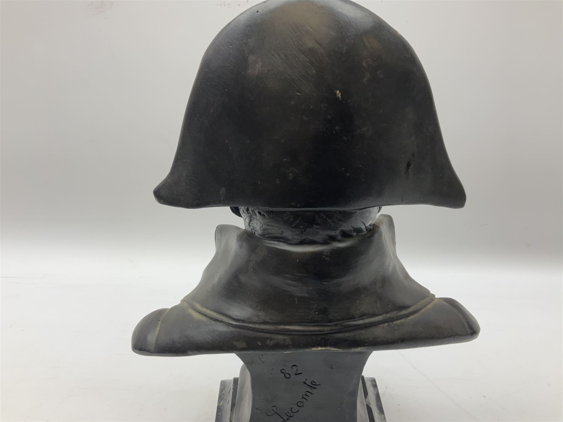 Bronze bust modelled as Napoleon, head and shoulders, wearing his hat and with open collar, on a tapering square section base, marked to the reverse 'Lecomte '82', H36cm