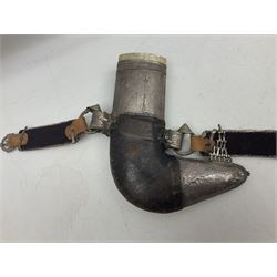 Omani Khanjar dagger, the 19cm curved blade with pronounced medial rib to either side, waisted hilt with dome shaped pommel and silver covered horn grip decorated with filigree bands, floral motifs and beadwork; in an intricately filigree decorated silver and leather scabbard with silver rings woven into the belt mount and fitted with original silver thread-work belt L34cm overall belt length 94cm