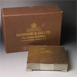 1960s silver mounted cigarette box, of rectangular form with engine turned decoration, upon four bracket feet, with presentation engraving to interior lid reading  'British Aircraft Corporation (Operating) Limited Commemorating the Queen's Award to Industry 1967, hallmarked James Geraghty, Birmingham 1965, with retailers mark for Asprey, W16.5cm, H4.5cm, in Garrard & Co Jewellers box