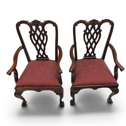 Chippendale design set of ten (8+2) mahogany dining chairs, serpentine cresting rails with carved detail over pierced ribbon-tied splats, red damask upholstered drop-in seats, on cabriole supports with acanthus carved knees and claw and ball feet