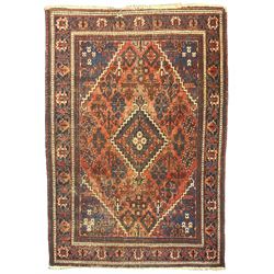  Persian Hamadan red ground rug, the field decorated with floral motifs with central lozenge medallion, guarded border decorated with repeating stylised plant motifs