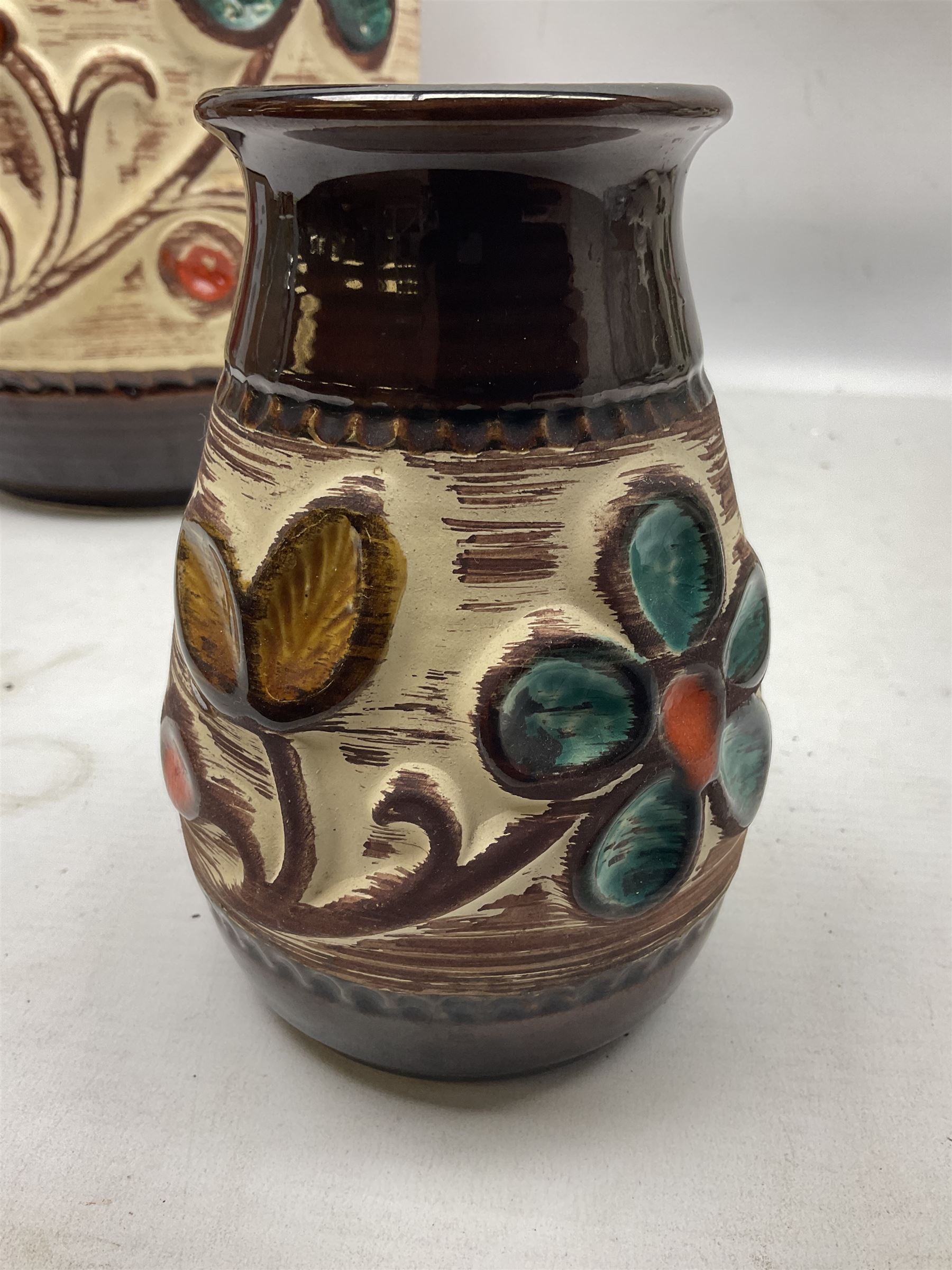 Pair of Bay West German vases, with bold moulded flower and foliage decoration in green, orange and ochre on brown ground, largest H40cm