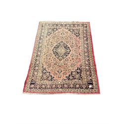 Persian Kashan carpet, blue shaped medallions and spandrels, the field decorated with interlacing branch and stylised plant motifs, repeating floral design borders